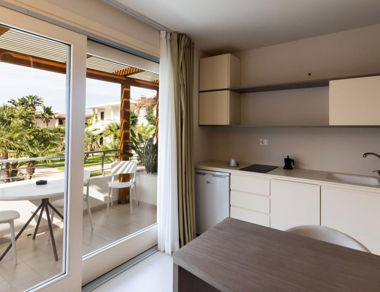 Modern kitchen with terrace and garden view.