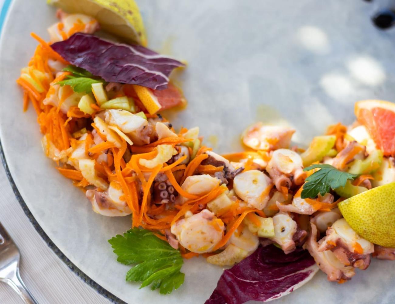 Octopus salad with fresh vegetables and citrus.